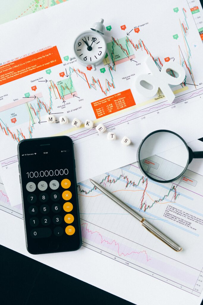 pexels-photo-6120182-6120182 Flat lay of charts, calculator, and magnifying glass on office desk for market analysis.
